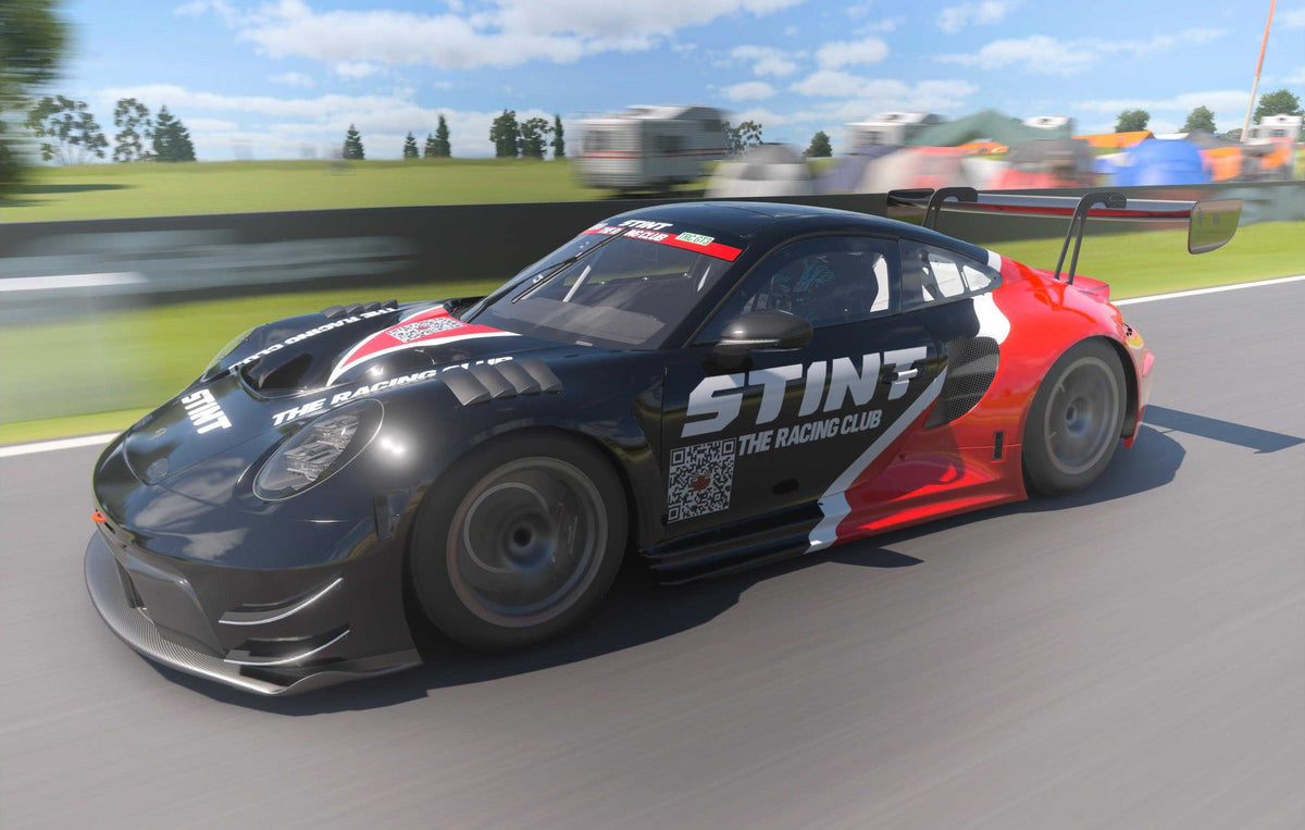 A GT7 Porsche carrying the STINT and The Racing Club marks on track.