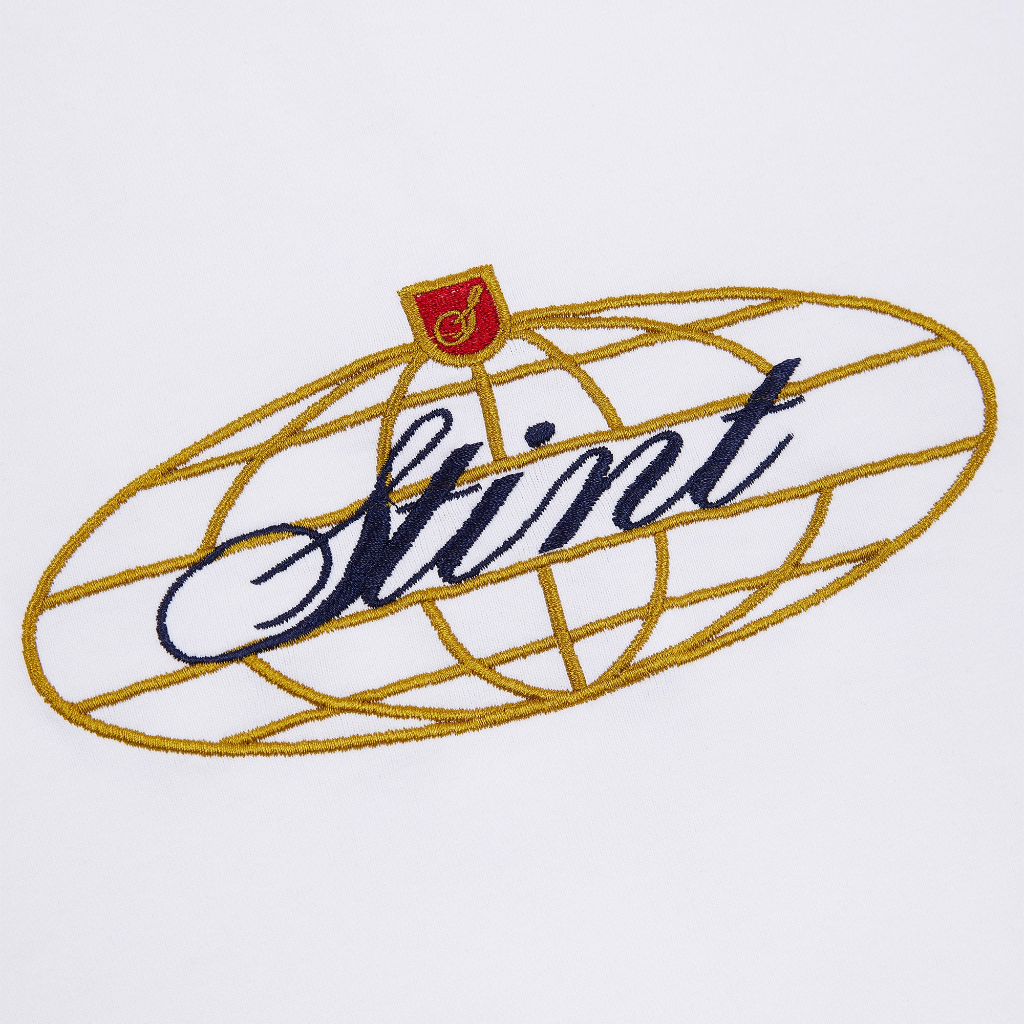 962 Tee by STINT GEAR. Close detail of the embroidered chest mark on white. Motorsport livery apparel.