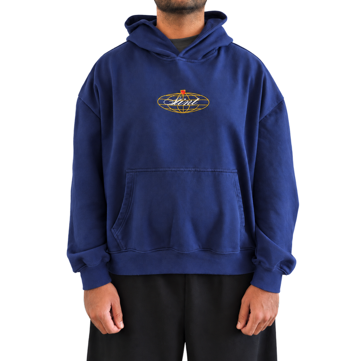 962 Hoodie by STINT GEAR worn front view. Blue, gold, and red on navy. Model wears size L.