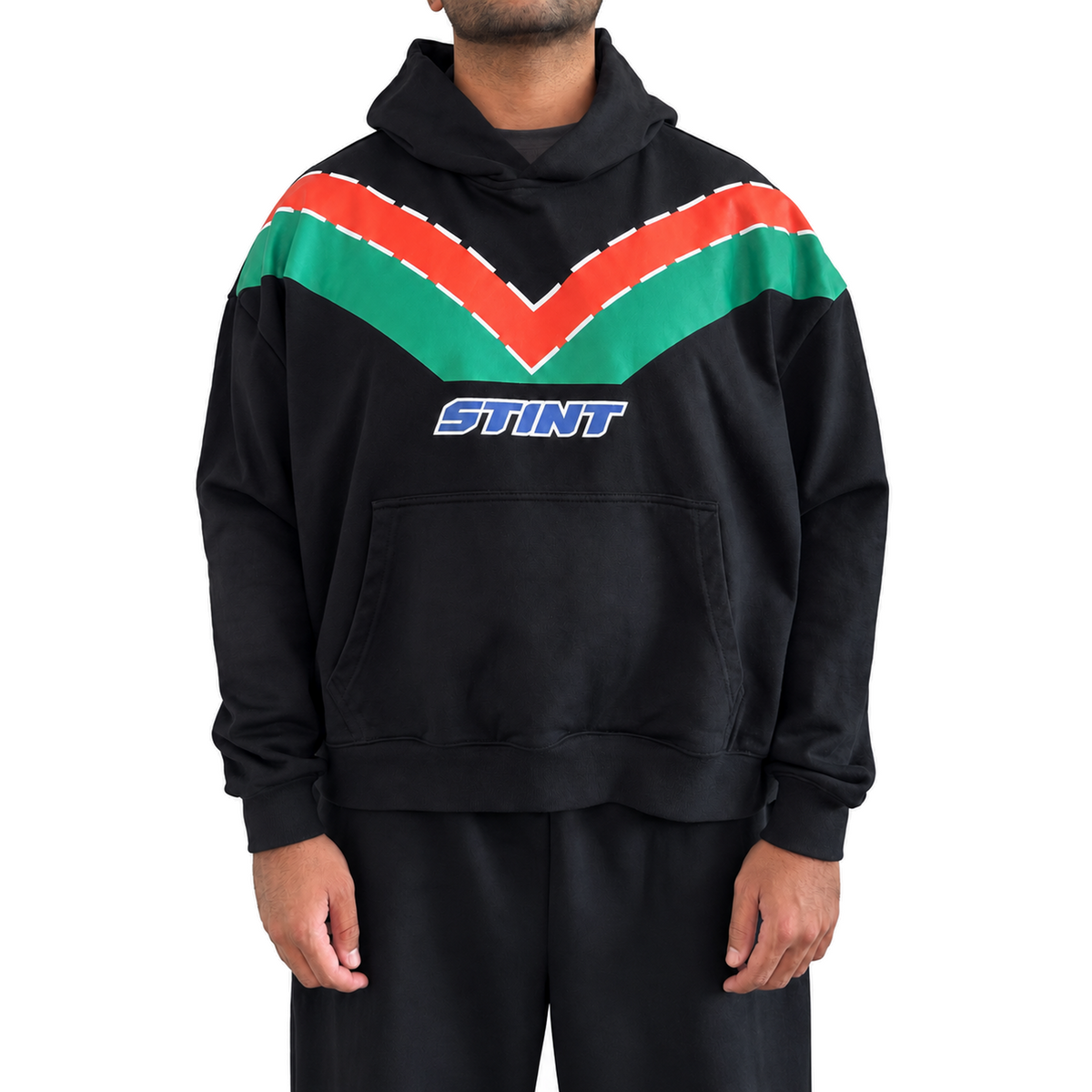 Rotary Hoodie by STINT GEAR worn front view. Orange and green on black. Model wears size L.