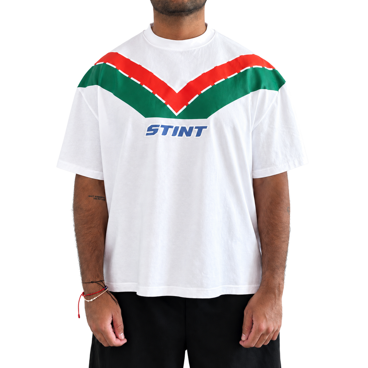 Rotary Tee by STINT GEAR worn front view. Orange and green on white. Model wears size L.