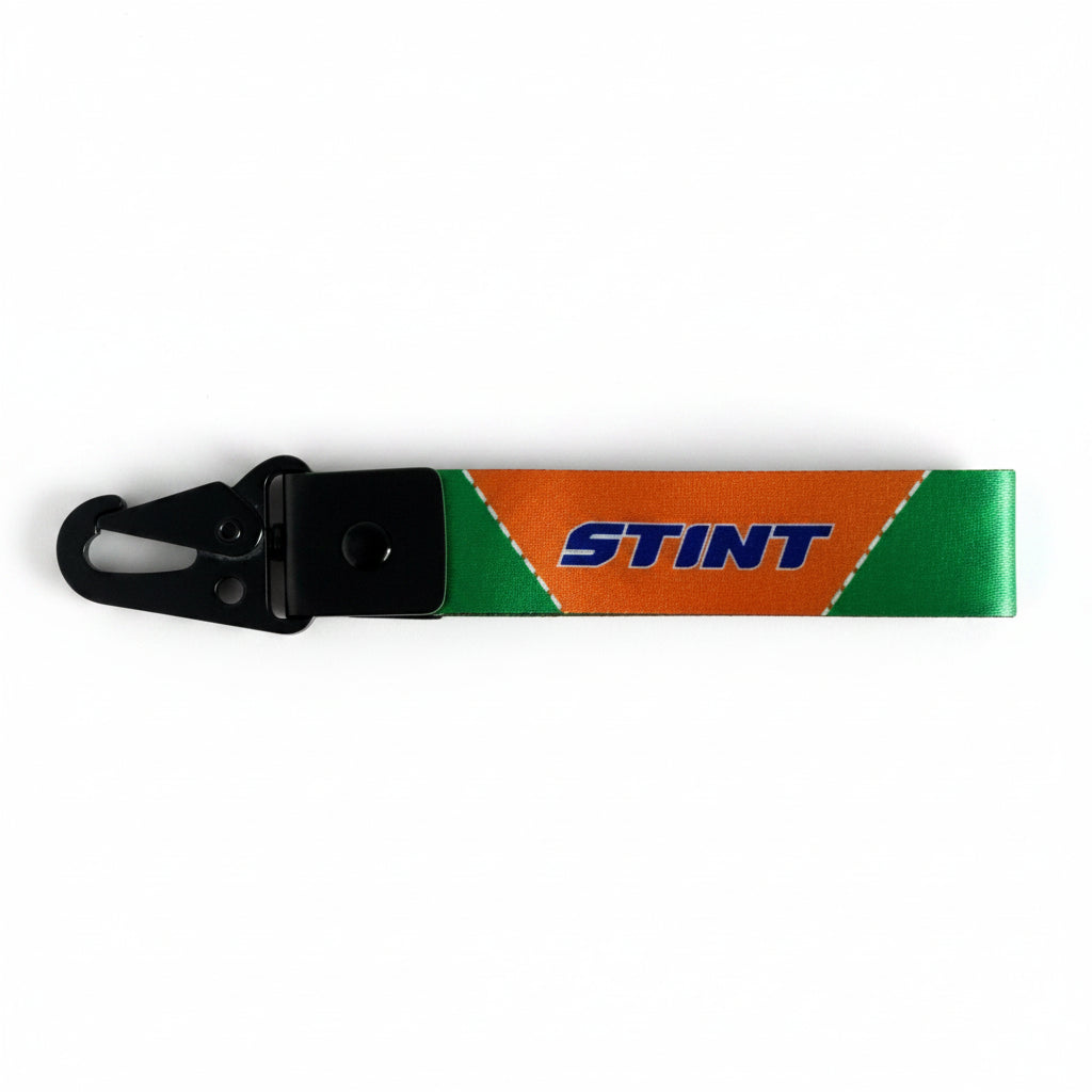 787B Keychain by STINT GEAR. Orange and green with woven lanyard strap.